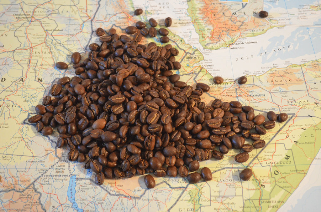 Many coffee beans piled on a world map / atlas 
